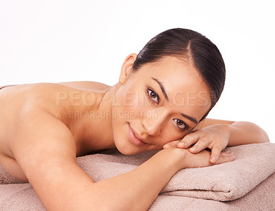 Buy stock photo Natural, portrait and woman at spa for massage with skincare, grooming or body treatment in studio. Happy, health and face of Asian female person on table for relaxing routine by white background.