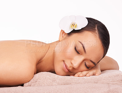 Buy stock photo A beautiful young woman relaxing on a massage table with her eyes closed