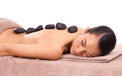 Buy stock photo Health, hot stone and woman with back massage at spa for wellness, self care and grooming treatment in studio. Skin, calm and person with masseuse for warm rock body routine by white background.