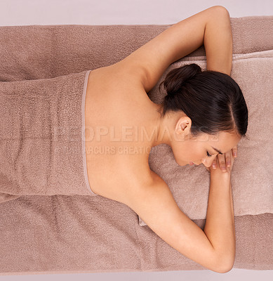 Buy stock photo A beautiful young woman lying on a bed at a day spa with her eyes closed