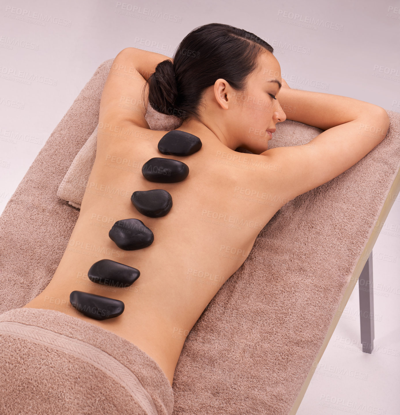 Buy stock photo Peace, woman and massage with hot stone therapy and wellness with vacation, relax or rocks. Natural, person or girl with stress relief or calm with holiday or healing with skin detox or luxury resort