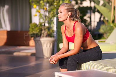 Buy stock photo Woman, thinking and exercise outdoor on patio for health, wellness and memory in sportswear for workout at home. Relax, reflection for training or fitness with fresh air, sun and challenge with sport