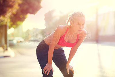Buy stock photo Tired woman, rest and fitness with break in city after workout, running or cardio exercise. Exhausted or determined female person or athlete in recovery, training or breathing from run in urban town