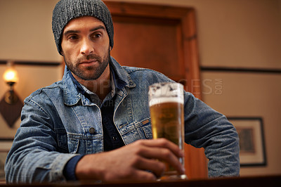 Buy stock photo Beer, pub and male person thinking with alcohol, drinks and restaurant for entertainment. Pensive, lonely and bar for thoughtful or social for relax, night and beanie for cold weather in England  