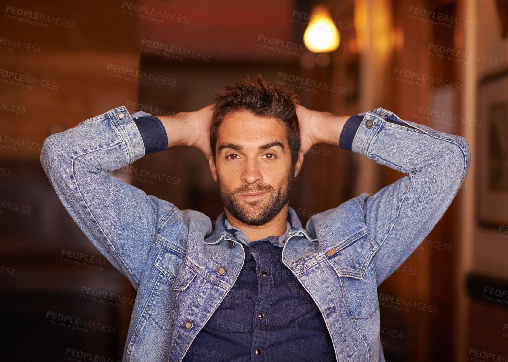Buy stock photo Portrait, smile and handsome male person in home, fashion and denim for relax or holiday. Confidence, smirk and style for man model with hands behind head, trendy and on vacation in Texas house