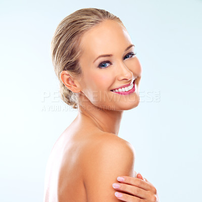 Buy stock photo Studio shot of a beautiful young woman with perfect skin against a blue background