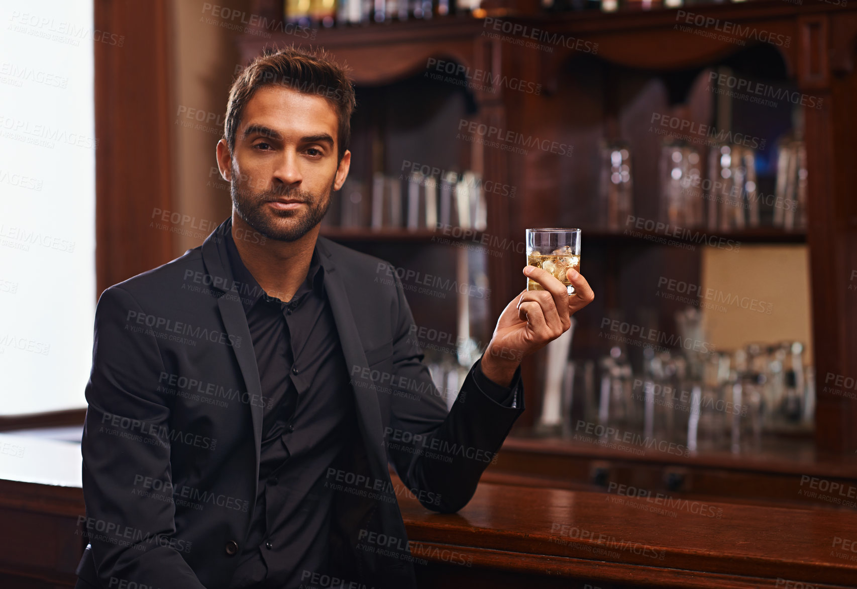 Buy stock photo Businessman, portrait or alcohol for break in bar, serious or drink to relax on startup project. Young person, hotel and face for whisky by counter at work and ambition of professional in hospitality