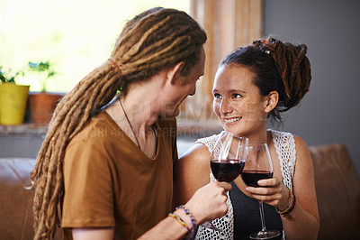 Buy stock photo Couple, wine and cheers for love, romance and joy for romantic, dating and relationship together for unwind. Boyfriend, girlfriend and rasta with glass and smile and relax with drink in lounge