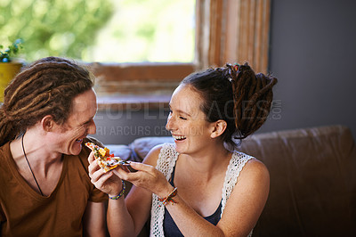 Buy stock photo Shot of a Rastafarian couple eating pizza 