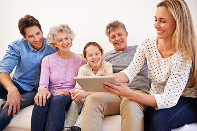 Buy stock photo Generations, tablet and family with smile, home and relax on sofa of living room for bonding. Grandparents, father and mother with technology for girl, growth and development of child with internet