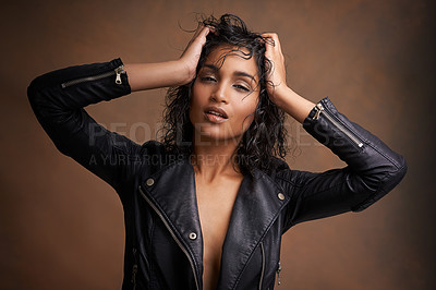 Buy stock photo Woman, fashion and portrait in studio with leather jacket and beauty with makeup for bold, and chic. Indian person, model and edgy with curls and clothes for aesthetic and style for trend and cool 