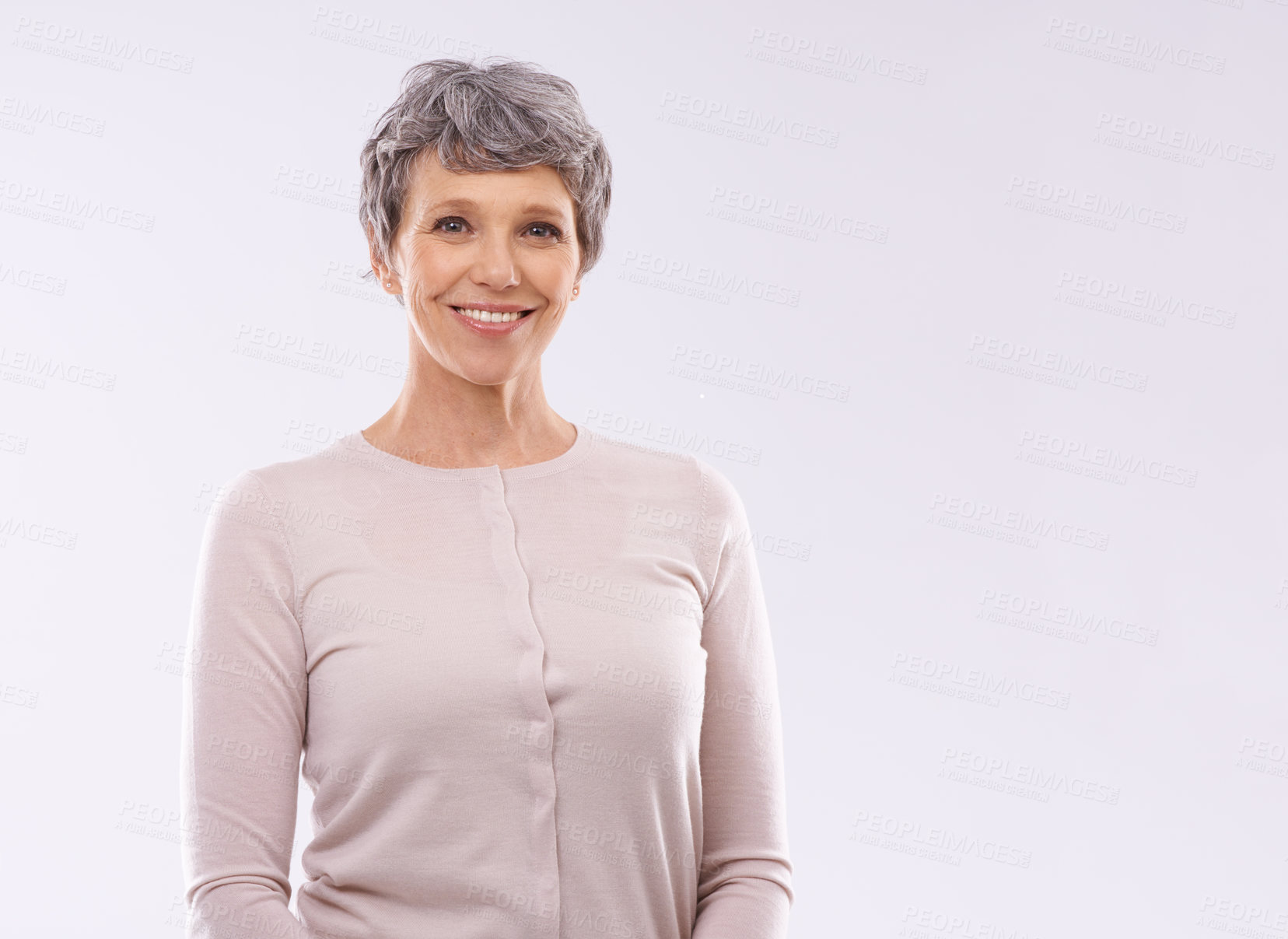 Buy stock photo Studio portrait of a happy mature woman against a white background