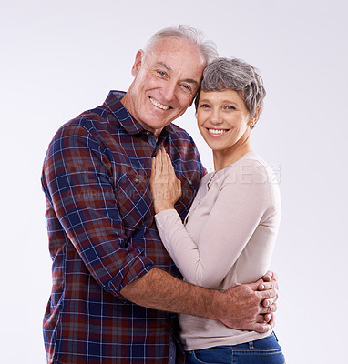 Buy stock photo Studio, hug and portrait of senior couple for bonding, affection and loving relationship. Marriage, happy and mature man and woman embrace for commitment, trust and care on white background together