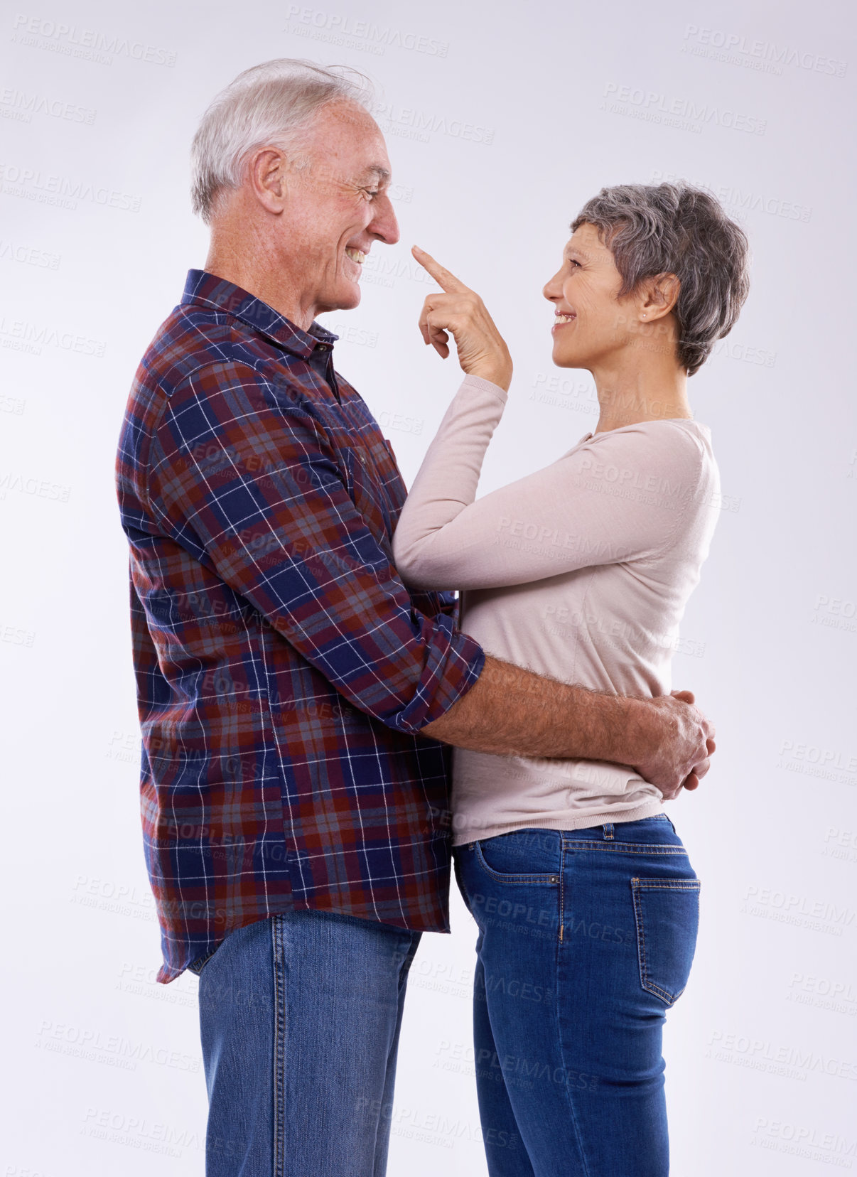 Buy stock photo Senior, couple and happy hug in studio together, smile and retired people in elderly love relationship. Pointing, female person with man on white background, affection on mockup space with joy