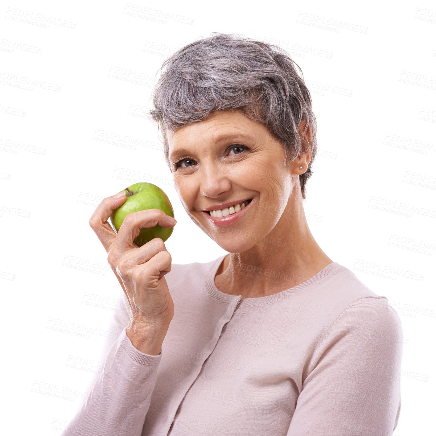 Buy stock photo Studio portrait of a happy mature woman holding an apple isolated on white