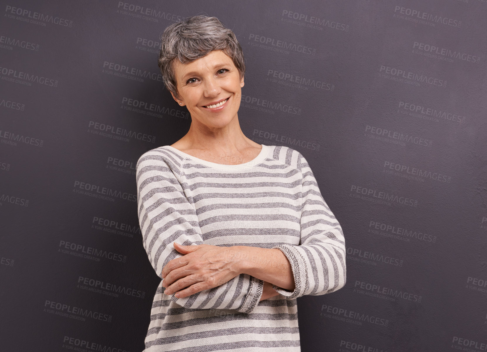 Buy stock photo Portrait, smile and senior woman with arms crossed, retirement and happiness on a grey studio background. Face, elderly person and mockup space with old lady and pensioner with joy, calm and cheerful