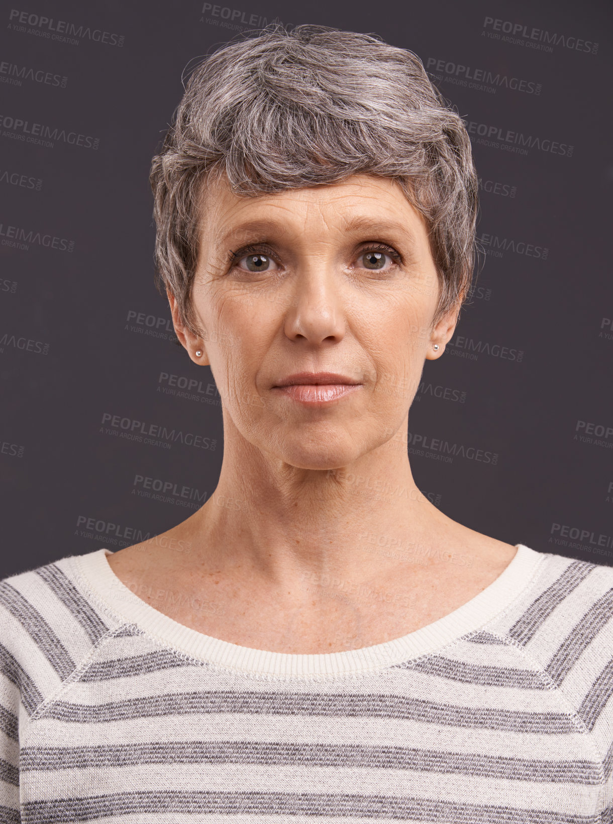 Buy stock photo Studio portrait of an elderly woman against a gray background