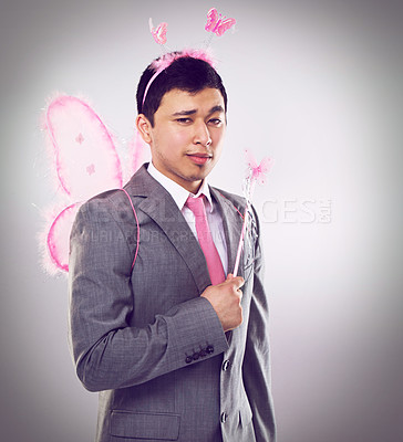 Buy stock photo Corporate, man in fairy costume and portrait with magic in business for career growth on grey background. Butterfly, wand and wings, fantasy cosplay for dress up or wish for professional progress