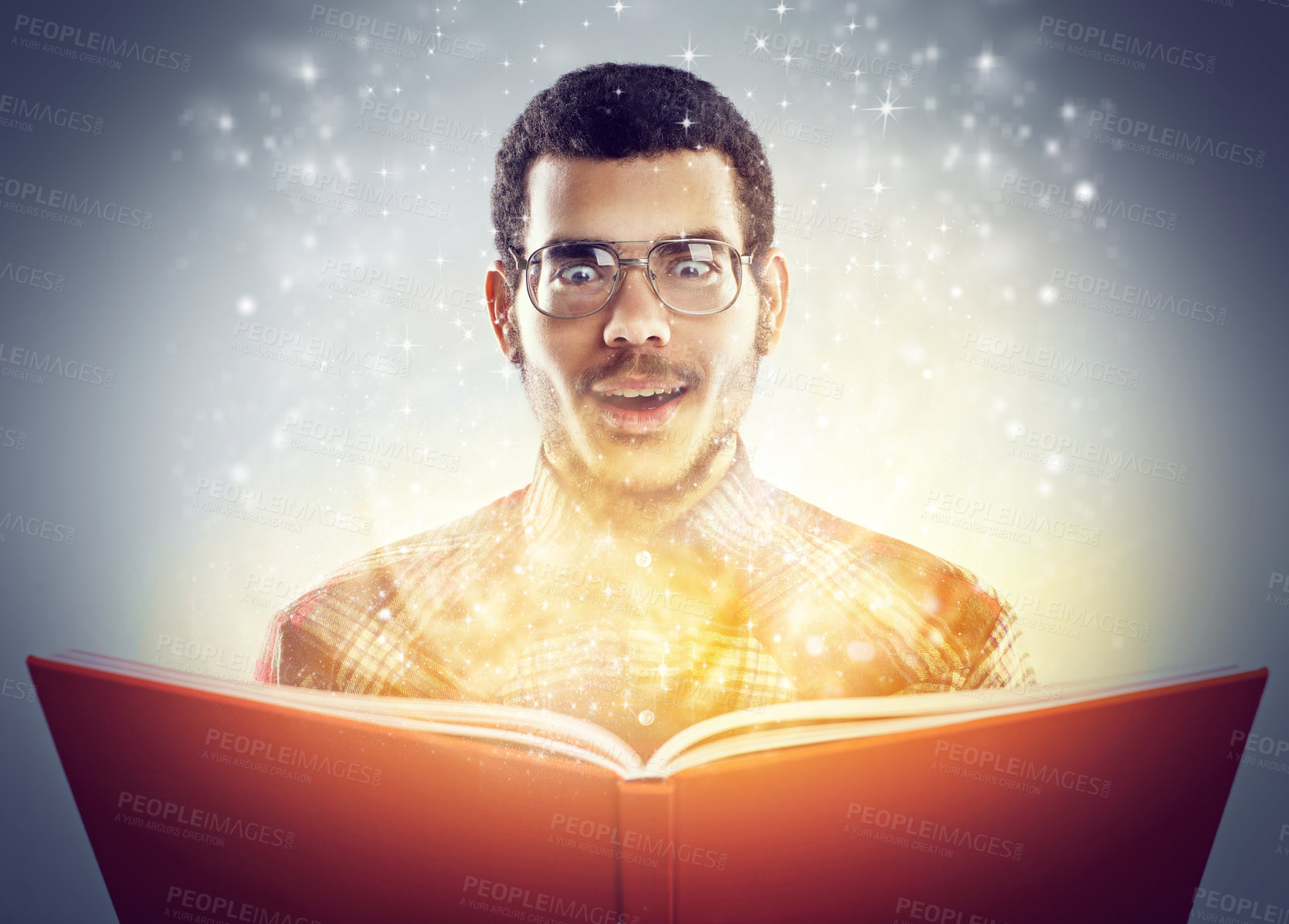 Buy stock photo A cropped shot of a young adult reading a book with glowing pages