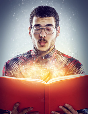 Buy stock photo Thinking, glowing book and man with story, fantasy and education on grey studio background. Person, model and guy with novel and literature with knowledge and learning with light, creative or magic