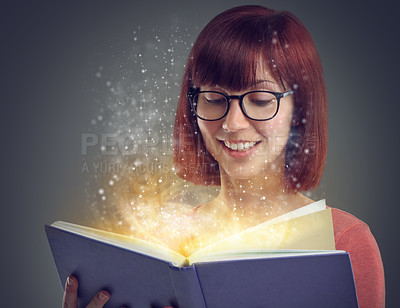 Buy stock photo Glowing pages, book or woman with a story, glasses or education on grey studio background. Person, reader or girl with a novel or literature with knowledge or eyewear with fantasy, smile or astrology