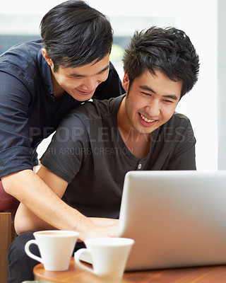 Buy stock photo Happy, streaming and a gay couple with a laptop for a movie, internet search or reading email. Smile, love and Asian men with a computer for online information, movie choice or show together
