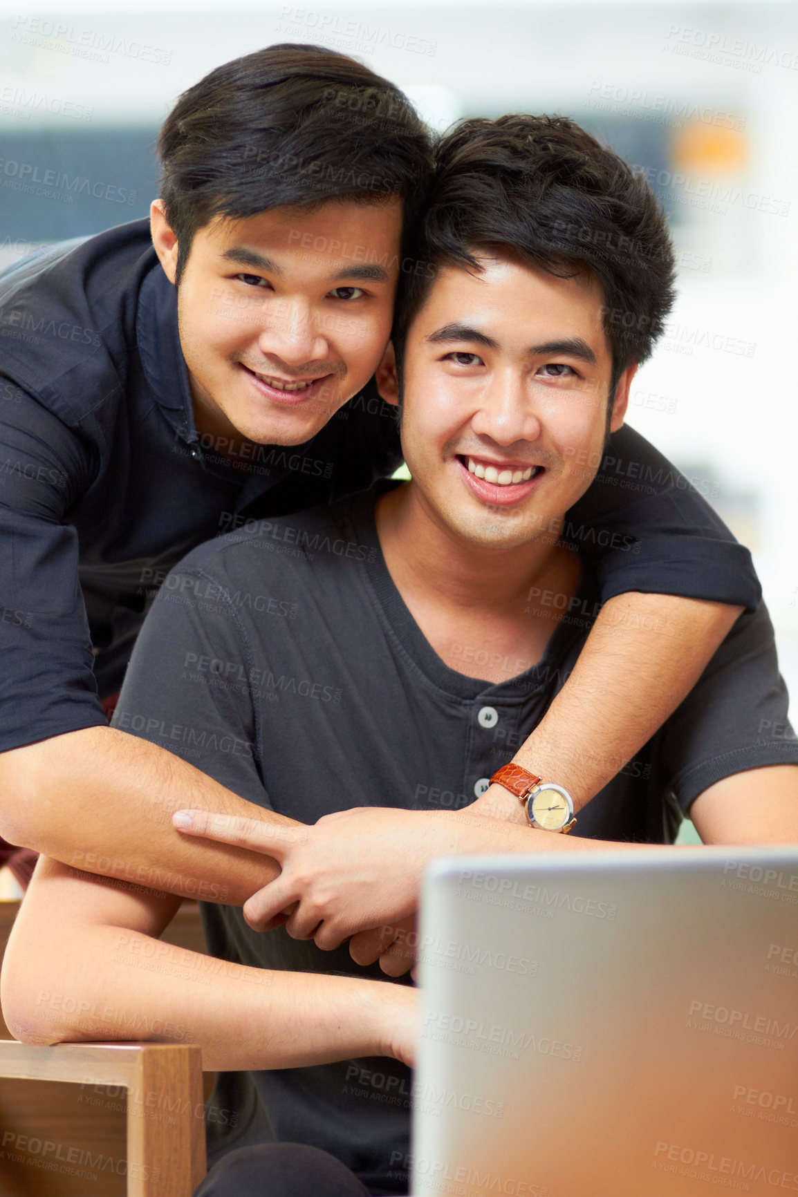 Buy stock photo Portrait of an affectionate young gay couple relaxing at home with a laptop