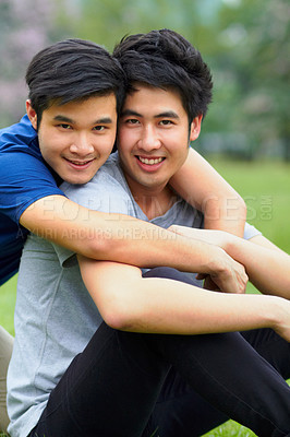 Buy stock photo Asian men, gay couple and hug in park portrait, grass or garden with love, care and bonding in summer sunshine. Happy Japanese guy, romance or relax together on lawn with lgbtq, nature and holiday