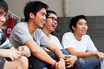 Buy stock photo Asian men, group and students at campus with smile, relax and excited together at college, education and outdoor. Happy Japanese friends, comic joke and laugh with solidarity at university in Tokyo