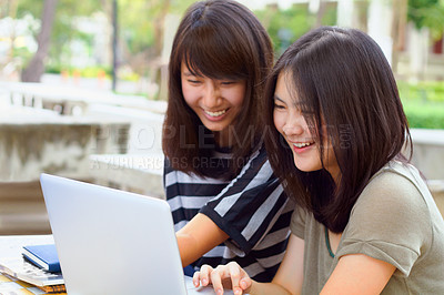 Buy stock photo Laptop, university and female students studying outdoor on campus for a test, exam or assignment. Happy, smile and women doing research or browsing for education information on a computer at college.