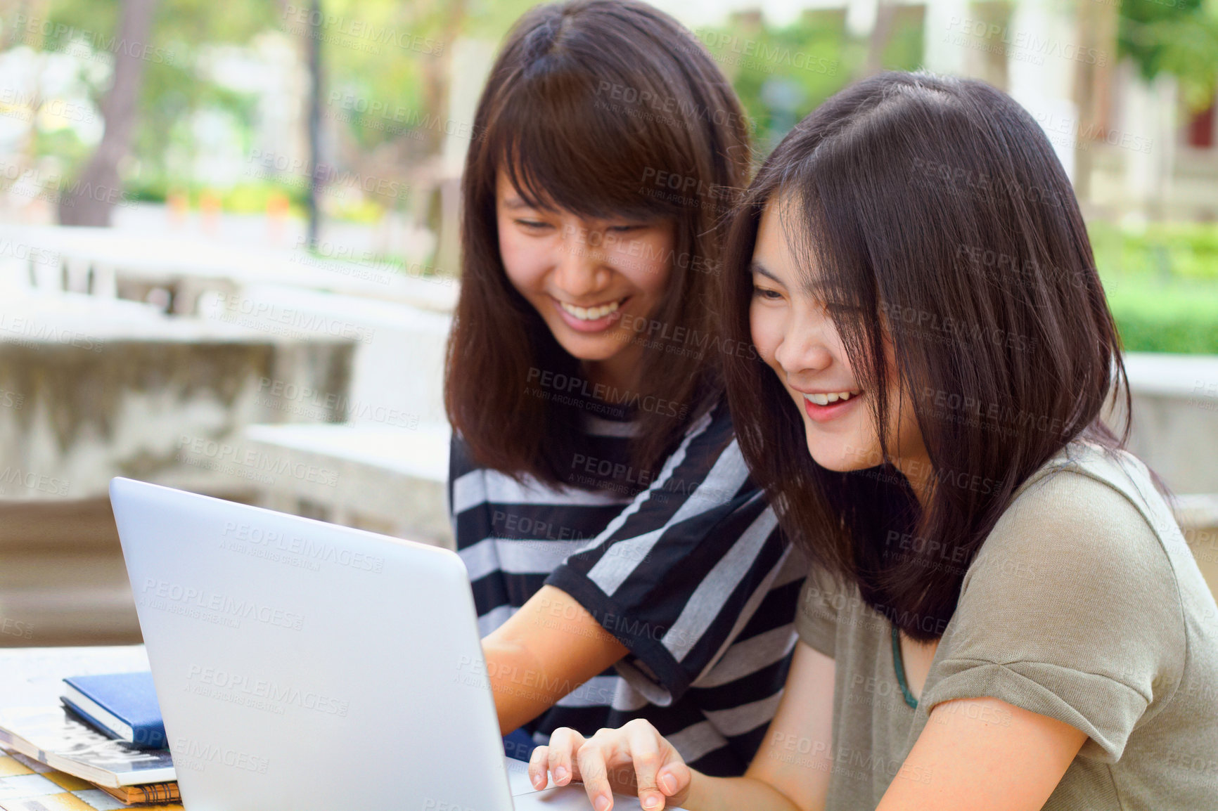 Buy stock photo Laptop, university and female students studying outdoor on campus for a test, exam or assignment. Happy, smile and women doing research or browsing for education information on a computer at college.