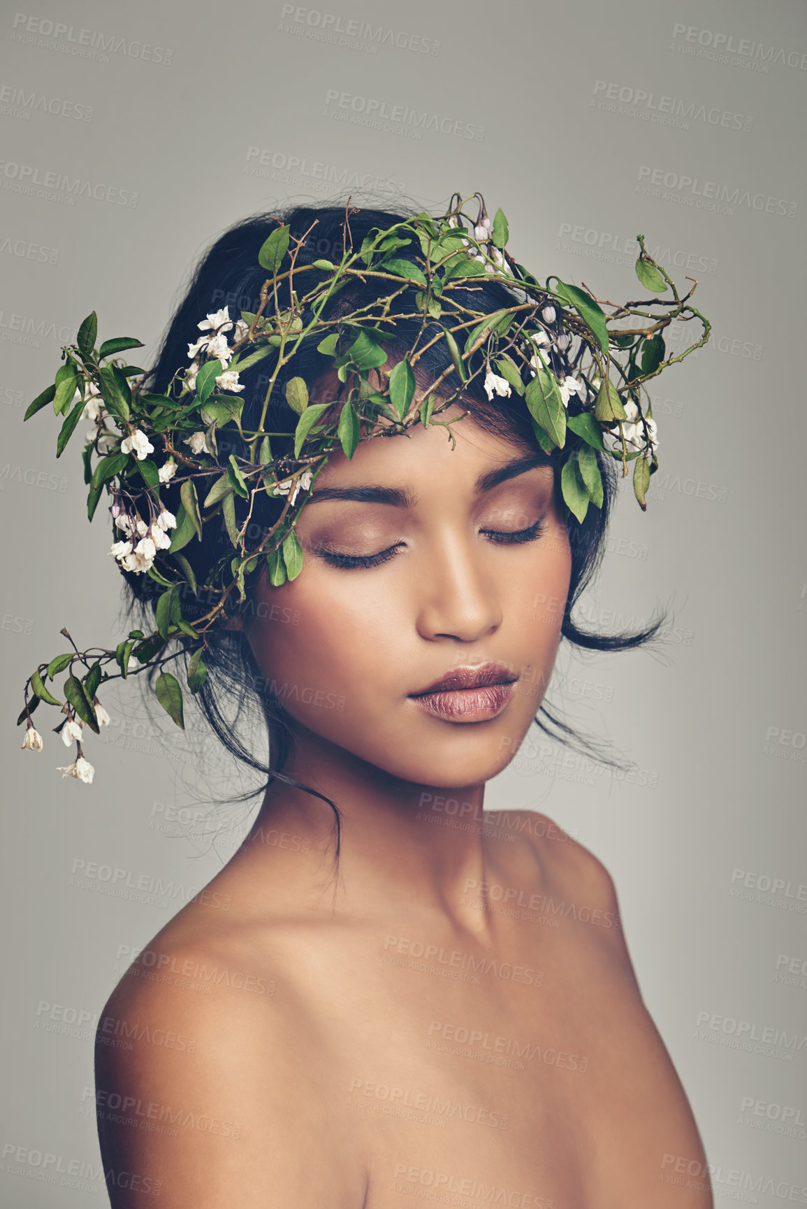 Buy stock photo Beauty, flowers and crown with a woman in studio on a gray background for natural skincare or treatment. Skin, nature and wellness with an attractive young female model wearing a flower wreath