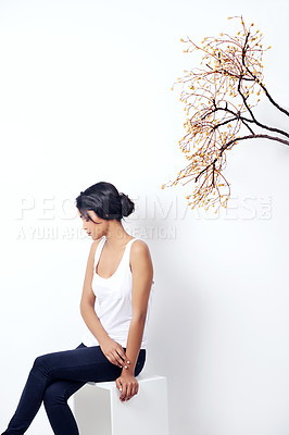 Buy stock photo Girl, tree and branch with fashion in studio with thinking, peace and growth in nature by white background. Woman, person and model with leaves, memory and relax on chair for ecology, art or ideas