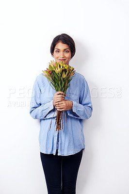 Buy stock photo Studio shot of an attractive young ethnic woman holding a bouquet of flowers