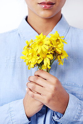 Buy stock photo Hands, woman and daisy bouquet in studio with closeup, fashion or sustainability by white background. Person, model and girl with yellow flowers, plants and organic shirt with ecology for environment