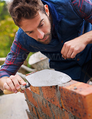 Buy stock photo Construction worker, bricklayer and man building a brick wall, handyman or contractor with trade in industry. Plastering, builder and cement with tools, maintenance and renovation for architecture