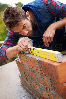 Buy stock photo Man, spirit level and construction for bricklayer, working employee in industrial industry and contractor career. Serious, male person and balance tool or handyman for renovation on building project