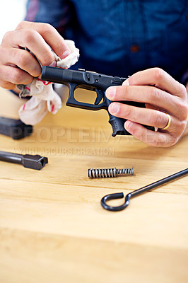Buy stock photo Hand, cleaning and man with gun equipment at table for safety, self defense and confident handgun assembly. Process, caution and person with firearm maintenance, cloth and wiping dust, dirt and tools
