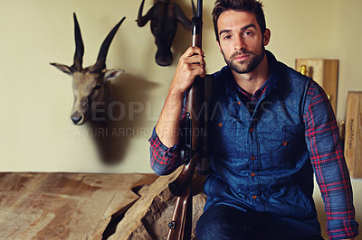 Buy stock photo Portrait, hunter and man with trophies, gun and confidence with business and resort with achievement. Face, person and game hunter with weapon and animal heads with firearm and equipment with pride