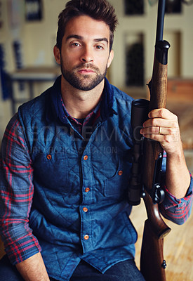Buy stock photo Hunter, confidence and portrait of man with gun for game shooting, adventure and hobby in home. Sports, trophy hunting and serious face of person in cabin with rifle, pride and sportswear in home