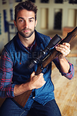 Buy stock photo Hunter, pride and portrait of man with gun for game shooting, adventure and hobby with confidence. Sports, trophy hunting and serious person in cabin with rifle, equipment and weapon gear in home