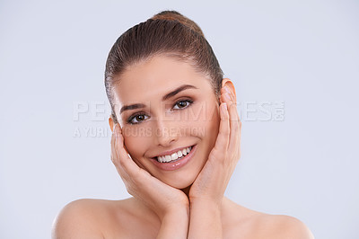 Buy stock photo Studio portrait of a beautiful young woman posing with her head in her hands