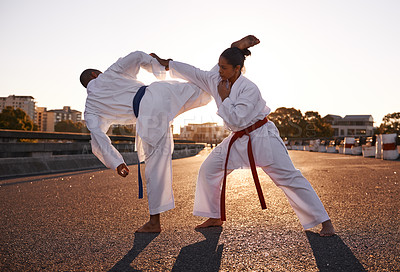 Buy stock photo People, karate and fighting with personal trainer in city street for self defense, technique or style. Man and woman fighter or athlete in fitness training, martial arts or kick boxing in urban town
