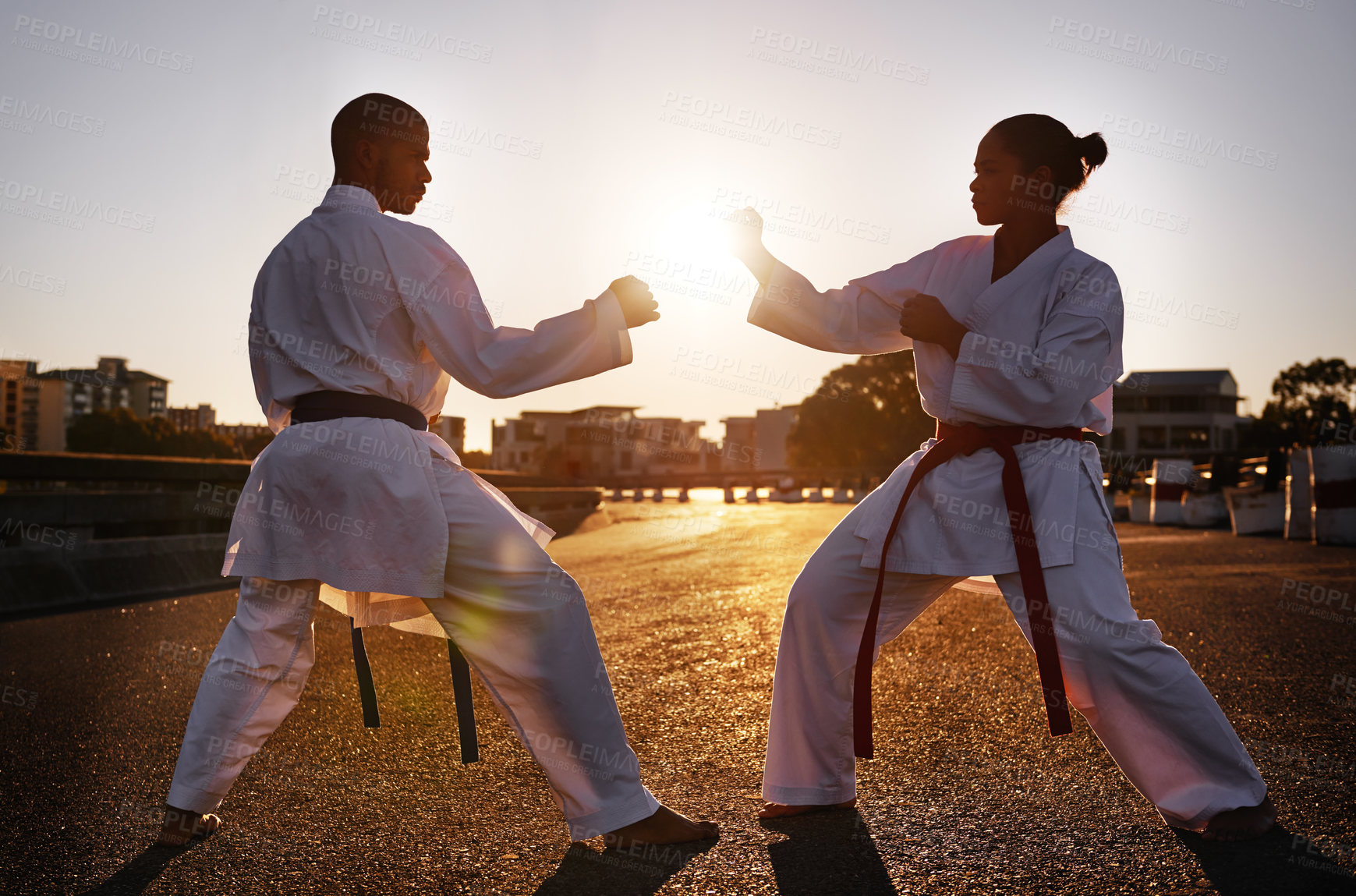 Buy stock photo Two sportspeople facing off and practicing their karate while wearing gi