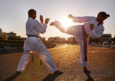 Buy stock photo People, karate and martial arts with personal trainer for self defense, technique or style in city street. Man and woman fighter or athlete in fitness training, fighting or kick boxing in urban town
