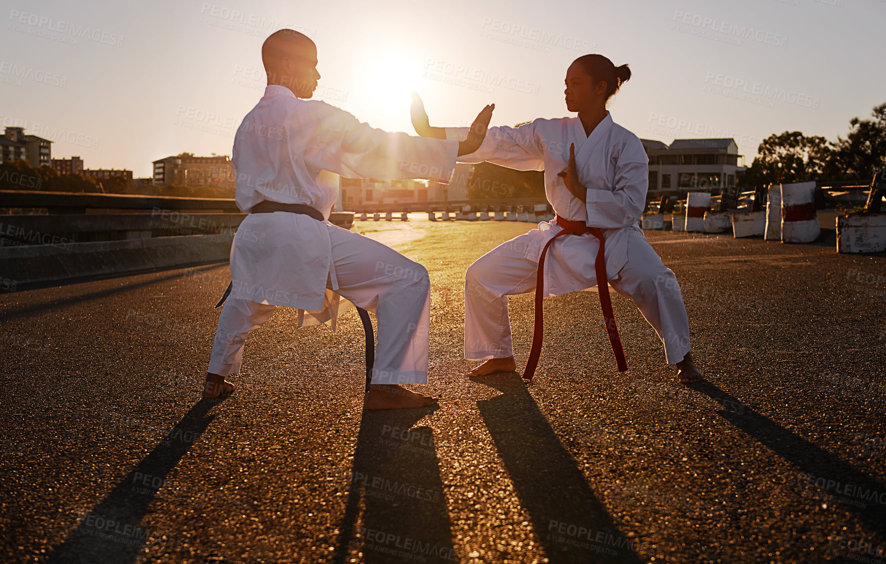 Buy stock photo Two sportspeople facing off and practicing their karate while wearing gi