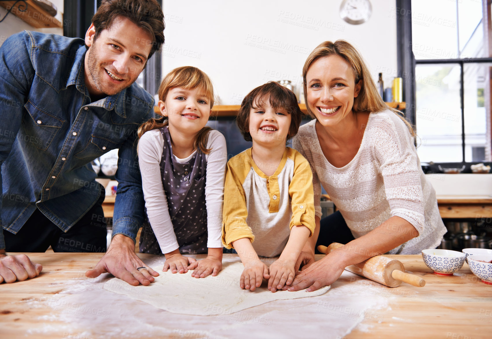 Buy stock photo Portrait, family and cooking pizza in kitchen together, counter with pastry or sauce for Italian food for supper. Smile, parents or children helping or support in preparation process in home for fun