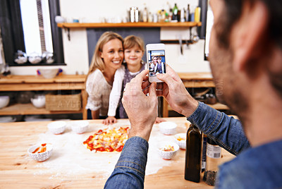 Buy stock photo Happy family, phone and picture in kitchen for baking pizza together with parents in home. Photography, cooking and smile of mother, father and girl child on smartphone screen for bonding in house