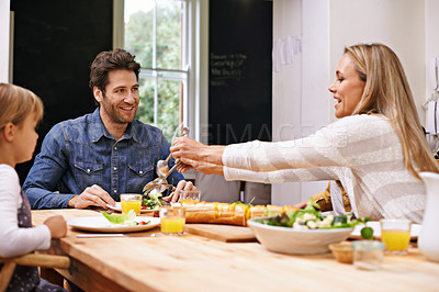 Buy stock photo A family sitting down to eat dinner together