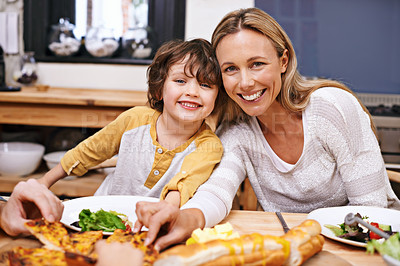 Buy stock photo A little boy and his mom eating dinner at the table